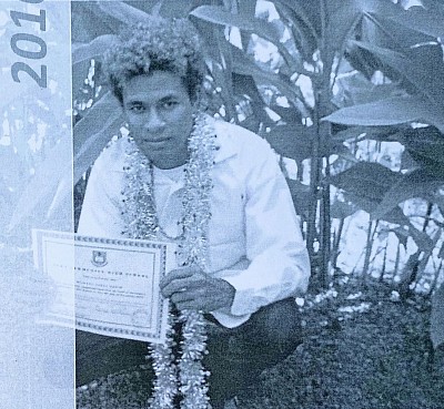 Hakim holding his Form 5 Certificate